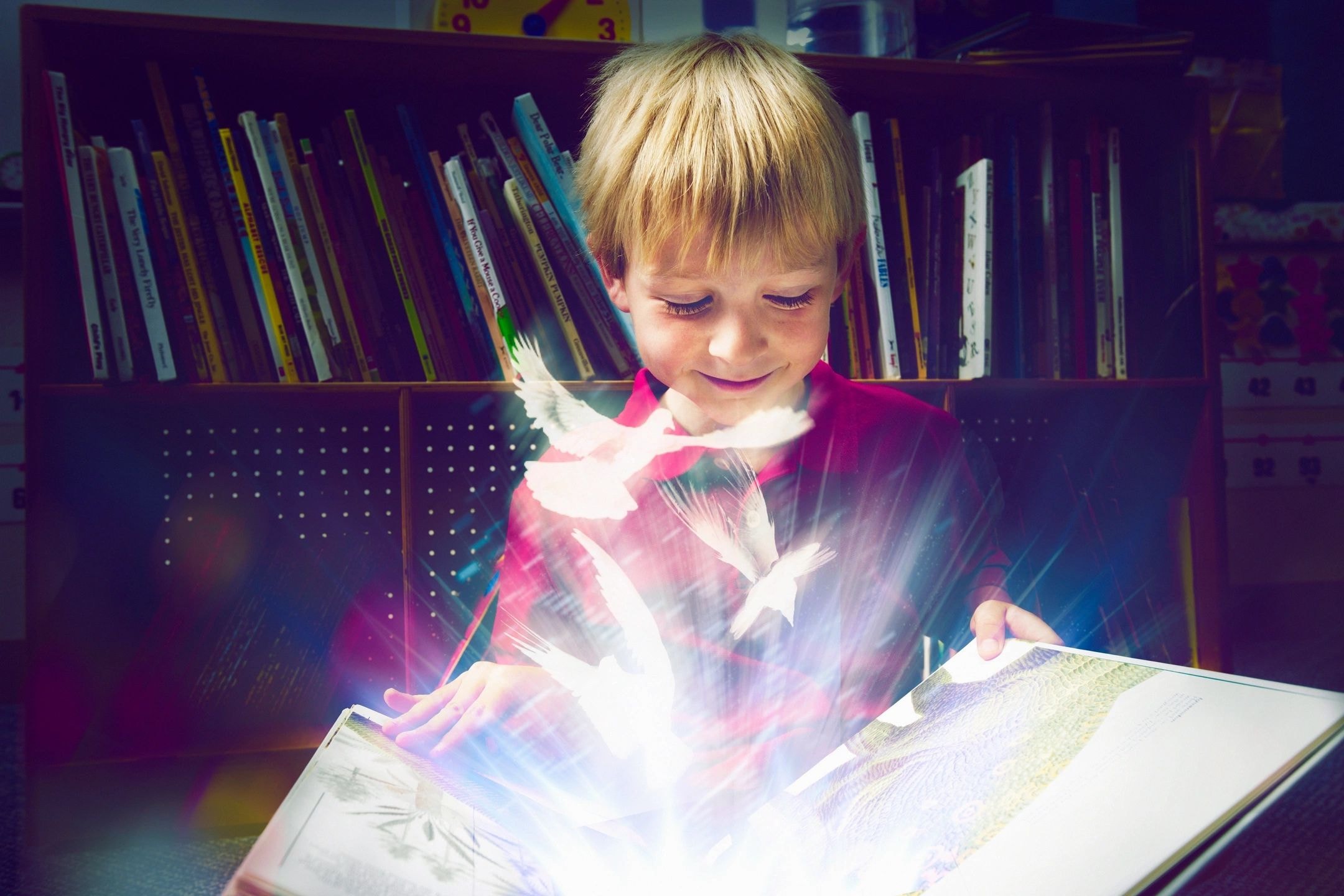 Child reading a magical glowing book
